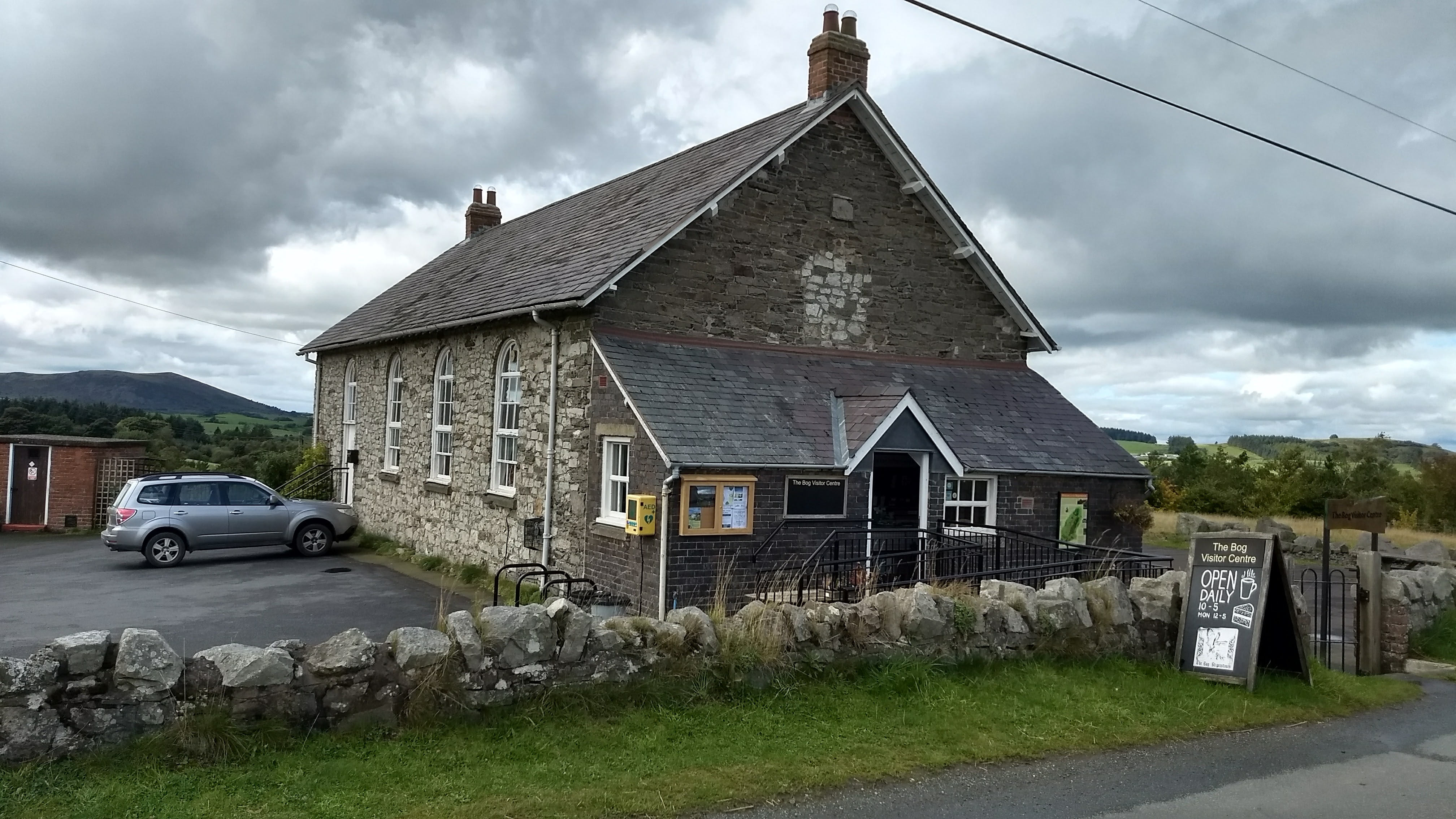 The Bog Visitor Centre building (former Victorian schoolhouse) with visitors outside